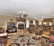 Living room with yellow walls white chair molding white baseboards wood floors brown brick fireplace with white mantle