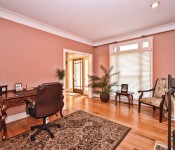 Room with orange walls wood floors white trim double doors floor to ceiling window