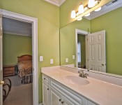 Bathroom with lime green walls white cabinets white countertop