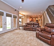 Room with brown walls windows with brown shades brown pattern carpet brown leather reclining chairs