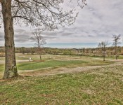 Golf course with grass and trees and a cloudy sky