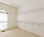 Empty closet with white walls white carpets white wire shelving