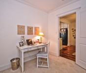 Bedroom with white walls dark wood ceiling fan white molding carpet flooring white furniture