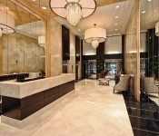 Lobby with large mirrors chandeliers sitting area main desk tile floors and tile walls