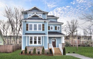 Three story home with vertical and horizontal blue siding and blue shingle details and brown stone details wood steps to front door dark wood shutters and front door white trim