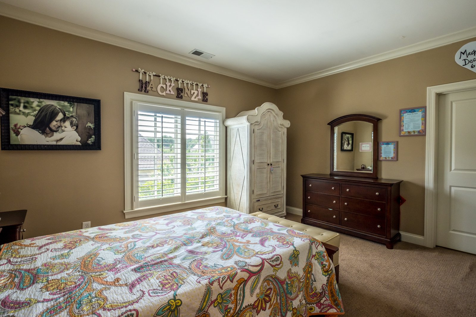 Bedroom with brown walls white trim light brown carpets