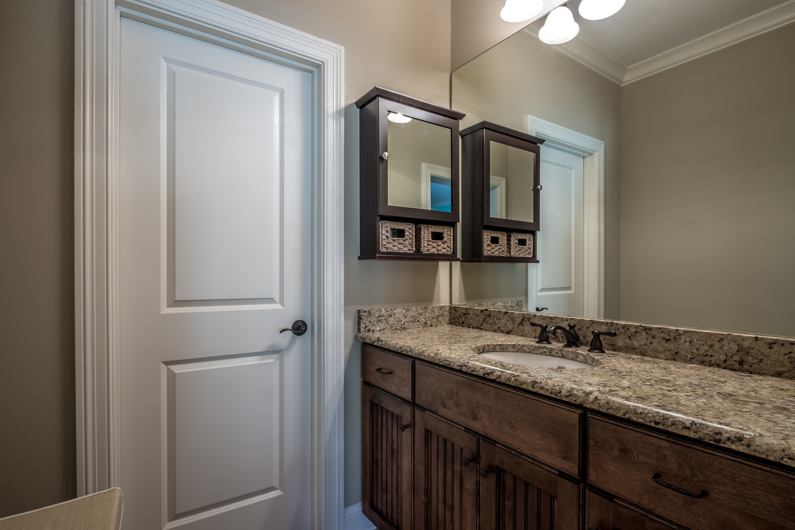Bathroom with brown walls dark brown cabinets brown granite countertops