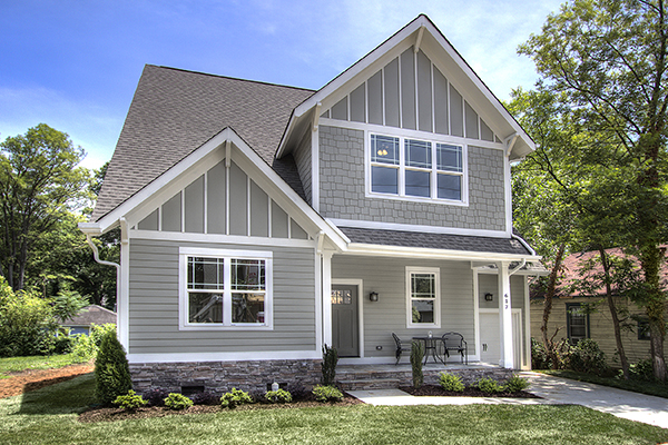 Two story home with gray siding and gray shingles white trim