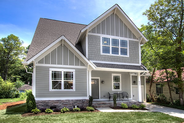 Two story home with gray siding and gray shingles white trim