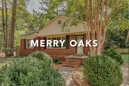 Brown brick home with black shutters and scallop trim around porch room and the words Merry Oaks typed over the image in white font
