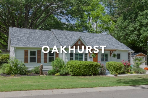 White siding home with brown shutters orange front door and the word Oakhurst typed over the image in white font