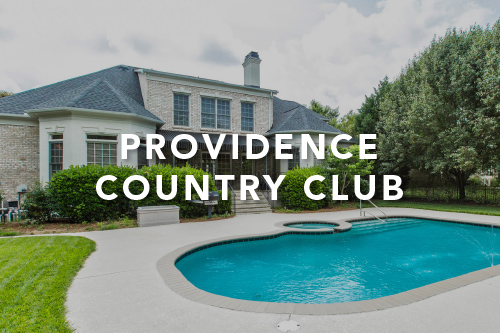 Back of a light gray brick home with built in pool and hot tub with the words Providence Country Club typed over the image in white font