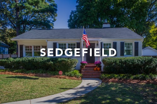 Home with white siding black shutters black front door brick steps America flag and the word Sedgefield type over the image in white font