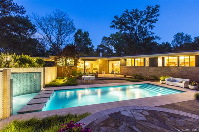 Brick home with lit built in pool