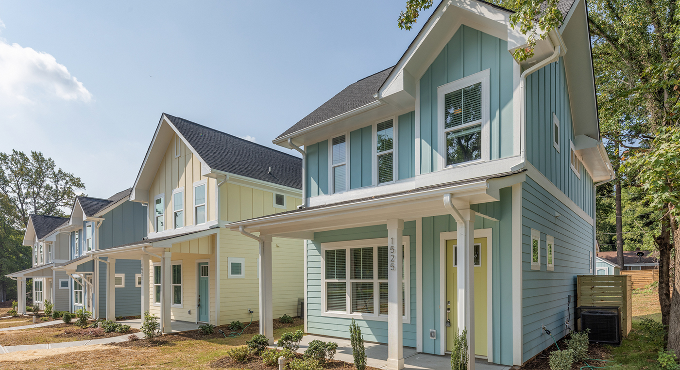 The Row on Walton Teal blue home with yellow front door front porch and white accents
