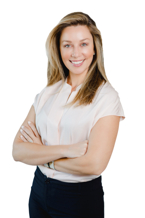 Sarah Martin_New Sarah Martin wearing a pink blouse and black pants standing in front of a white backdrop